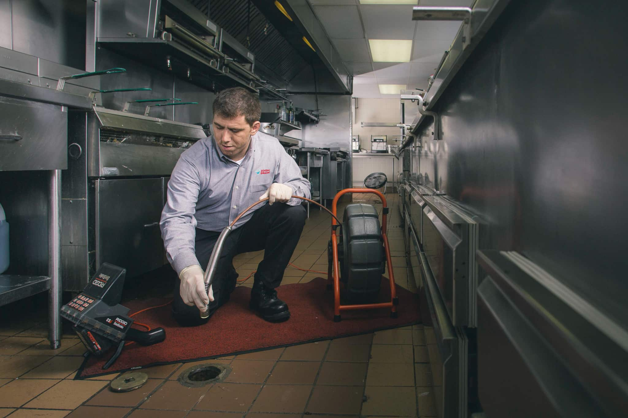 zoom drain employee doing a drain cleaning