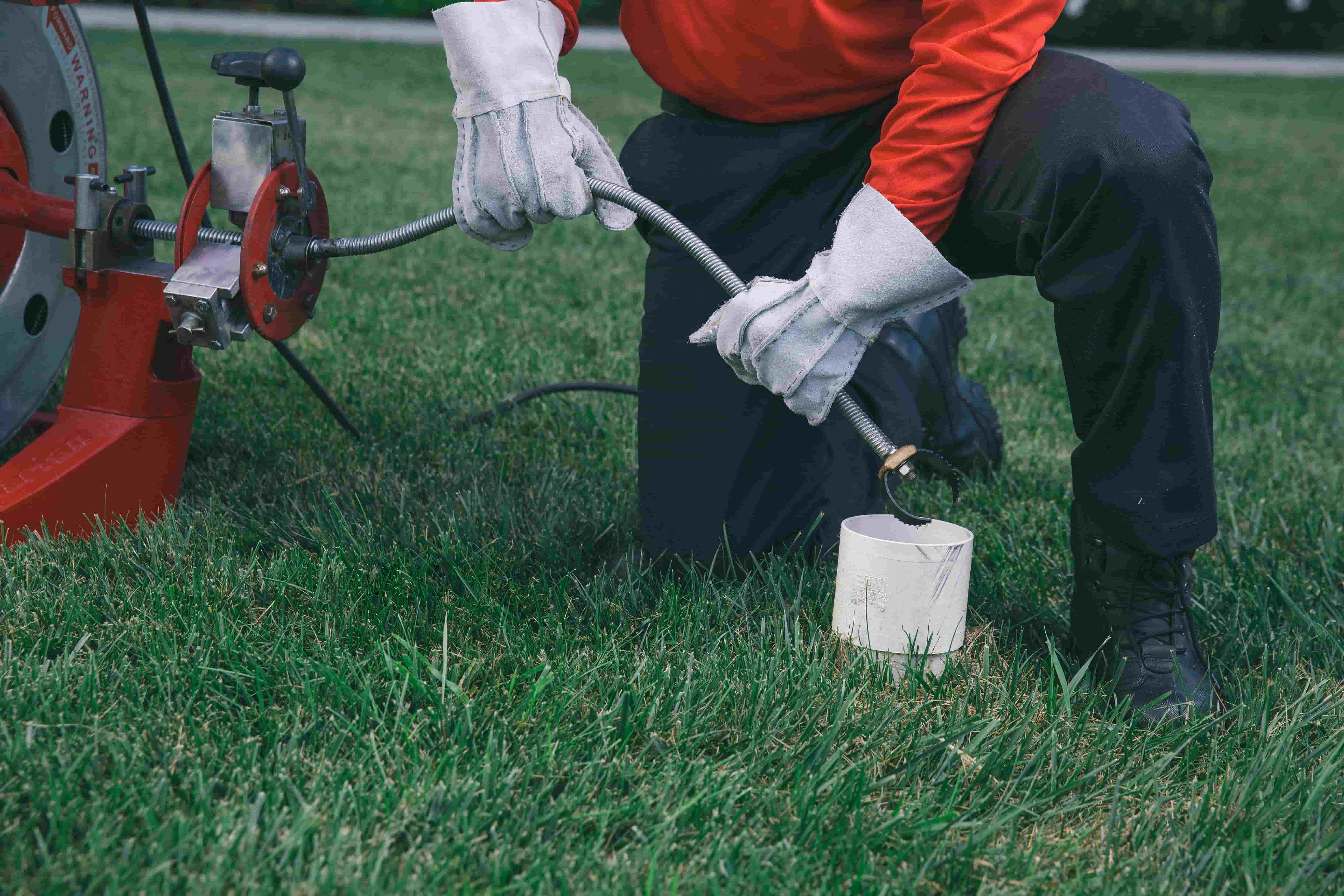 zoom drain employee cleaning a drain