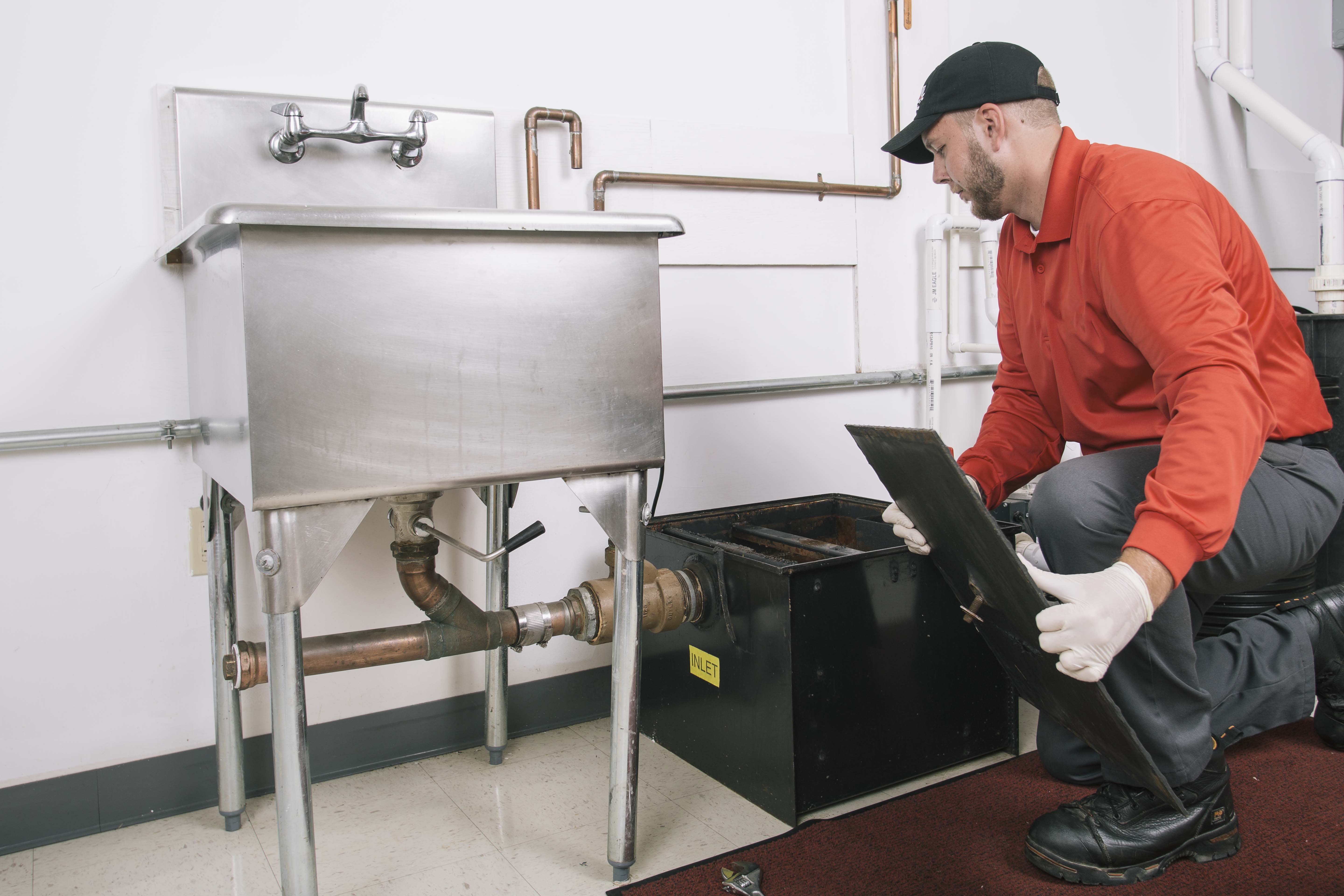 zoom drain employee working on a grease trap