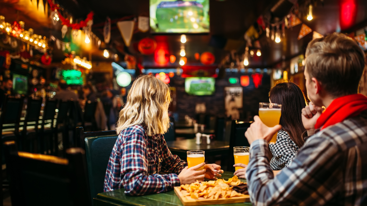 People Watching Sports And Eating At A Restaurant